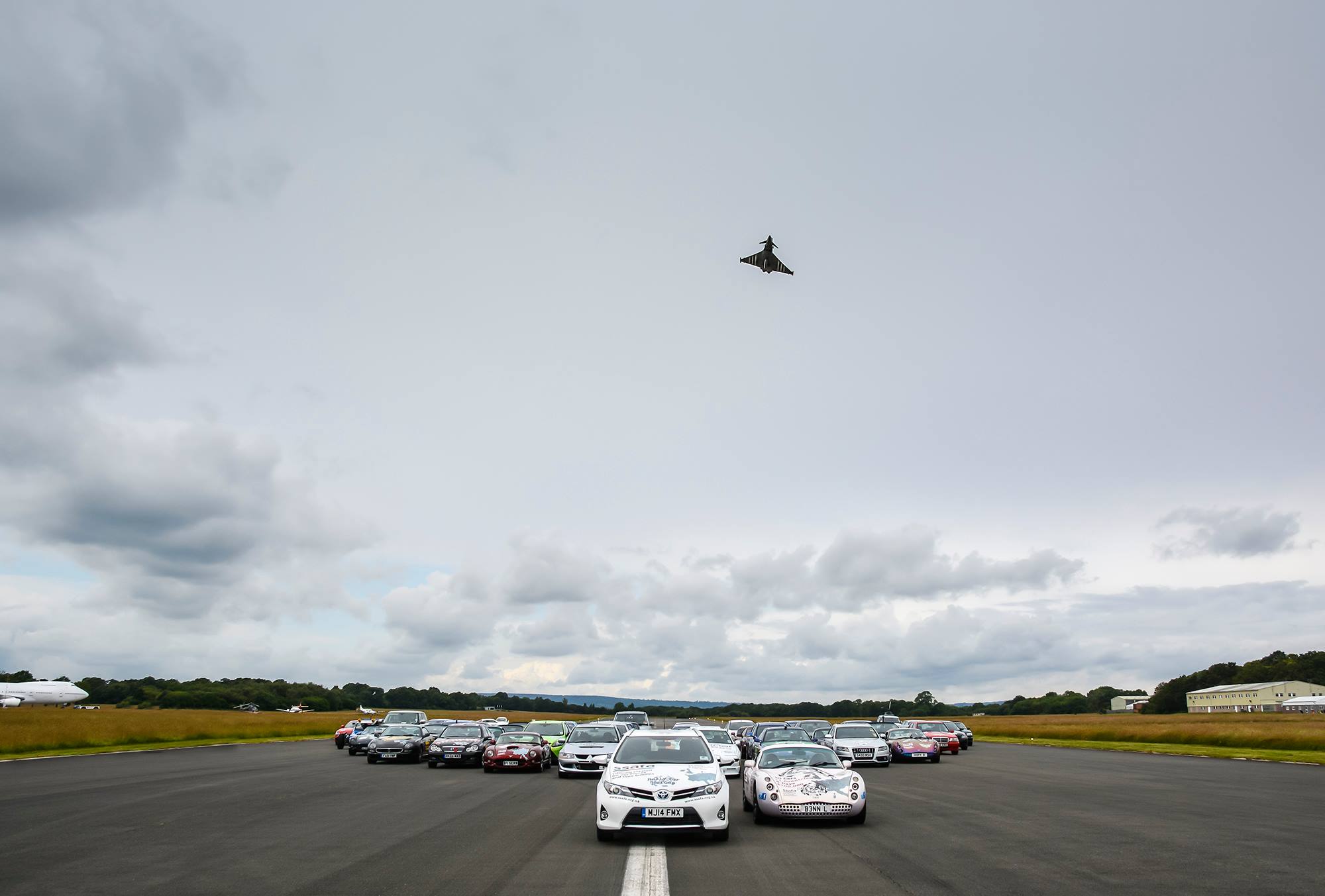 An airplane is flying over a parking lot - Pistonheads