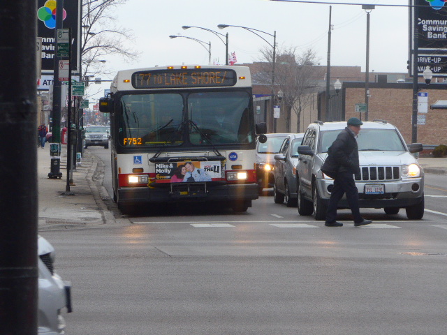 A city bus driving down a city street