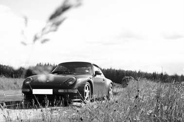 A black and white photo of a car parked in a field - Pistonheads