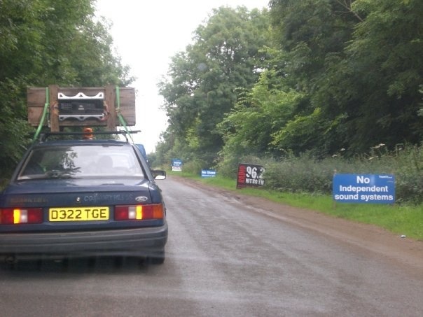 A truck driving down a road next to a forest - Pistonheads