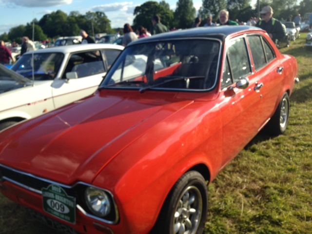A red car is parked in a field - Pistonheads
