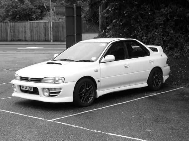 A black and white photo of a car parked in a parking lot - Pistonheads