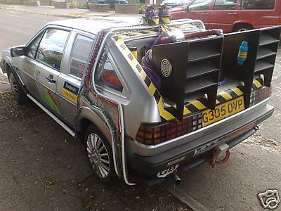 A car with a surfboard on top of it - Pistonheads