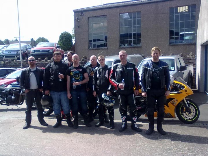 A group of people standing next to a motorcycle - Pistonheads