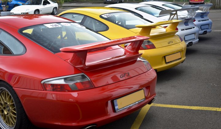 A red and yellow car is parked in a parking lot - Pistonheads