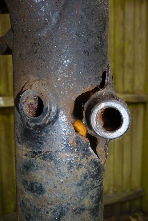 A rusted fire hydrant sitting on the side of a road - Pistonheads