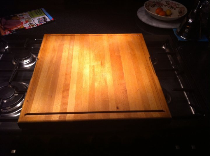 A wooden table topped with a white plate and a cup - Pistonheads