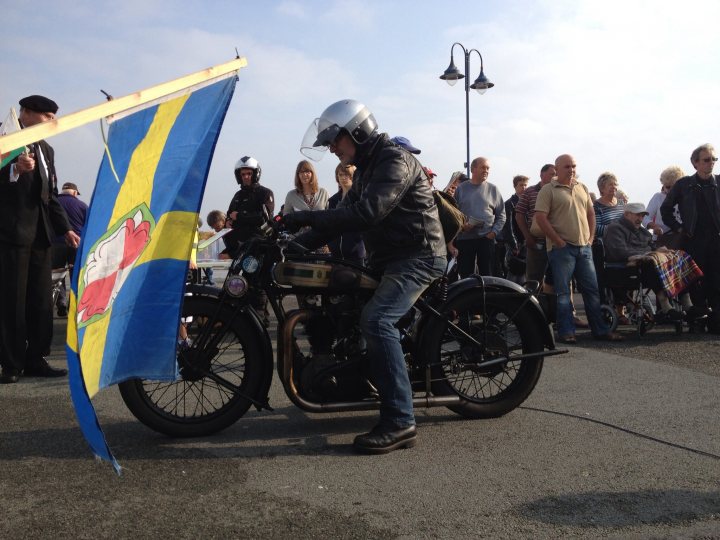 A group of people standing around a motorcycle - Pistonheads