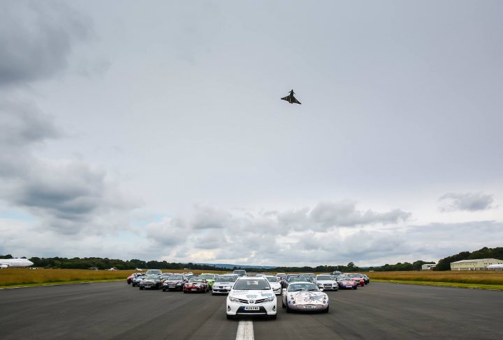 An airplane is flying over a parking lot - Pistonheads