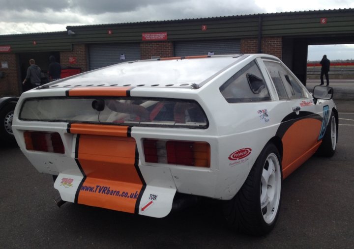 A car with a surfboard strapped to the back - Pistonheads