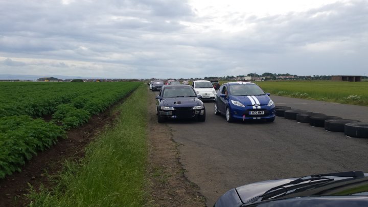 A group of cars parked on the side of a road - Pistonheads