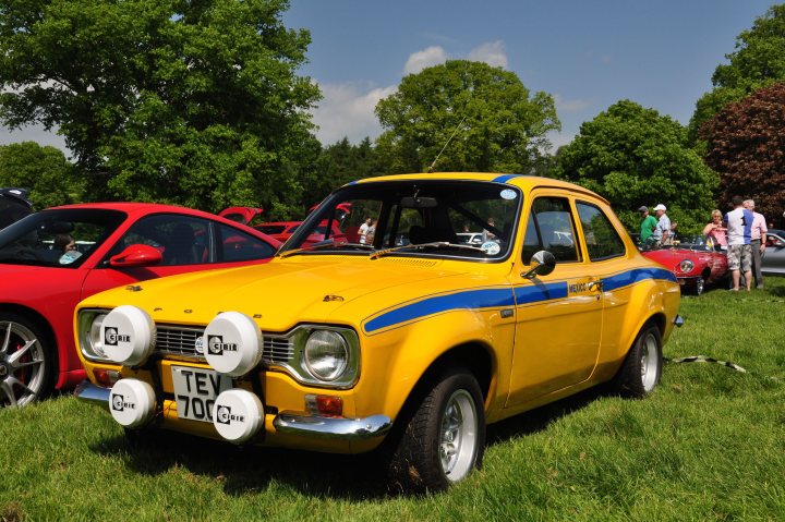 A red car is parked in a field - Pistonheads