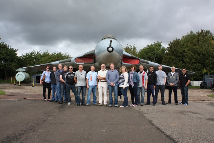 A group of people standing next to an airplane - Pistonheads