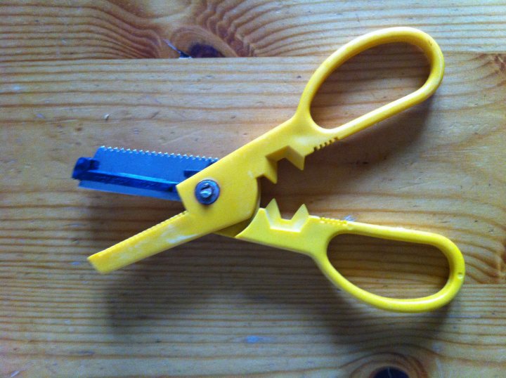 A pair of scissors sitting on top of a table