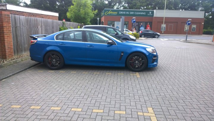 A blue car parked next to a parking meter - Pistonheads