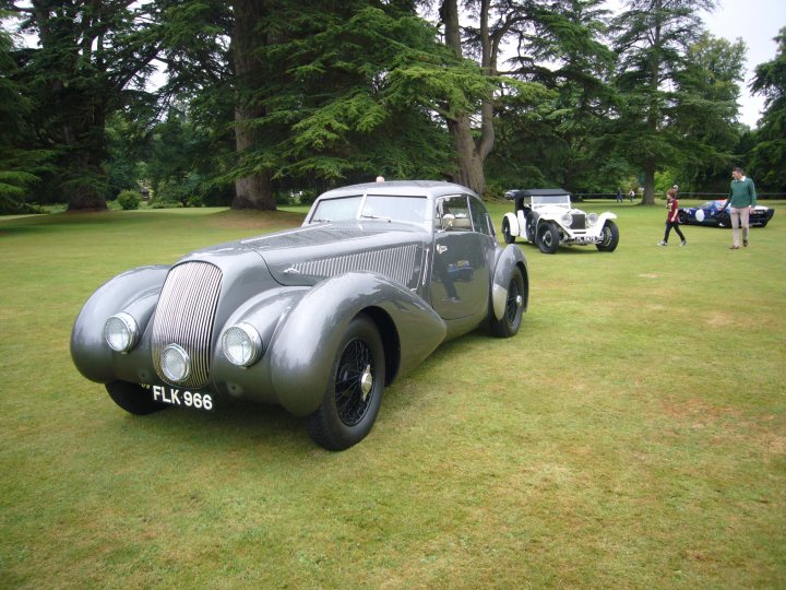 A vintage car is parked in a field - Pistonheads