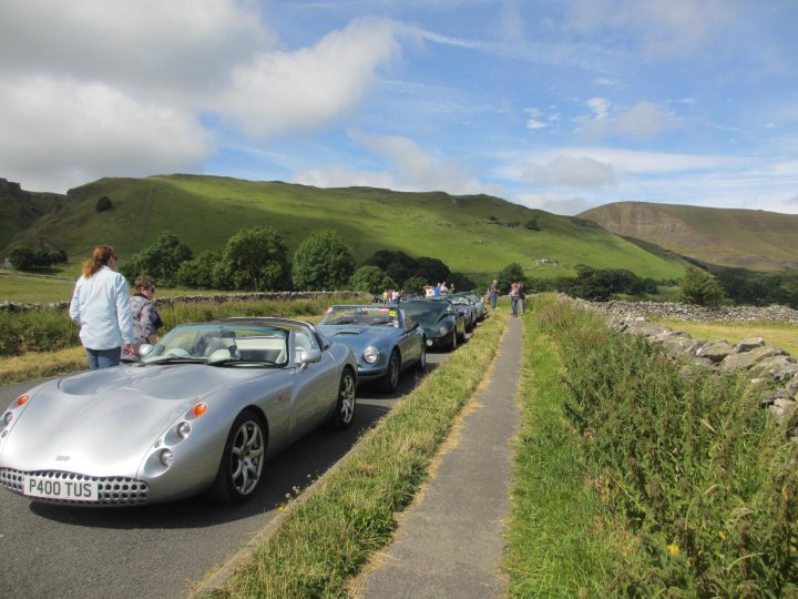 A group of people standing around a car - Pistonheads