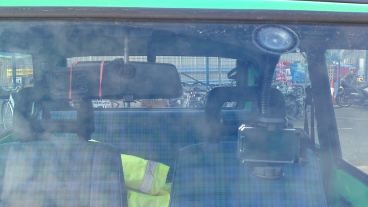 A man sitting on a bus with a bag of luggage - Pistonheads