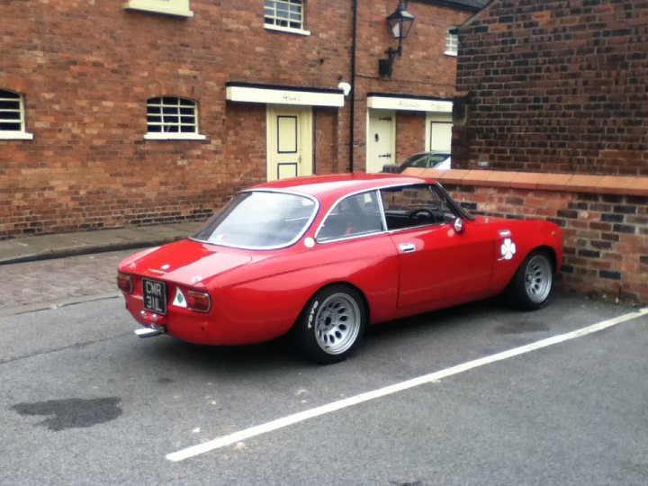 A red car is parked on the side of the road - Pistonheads