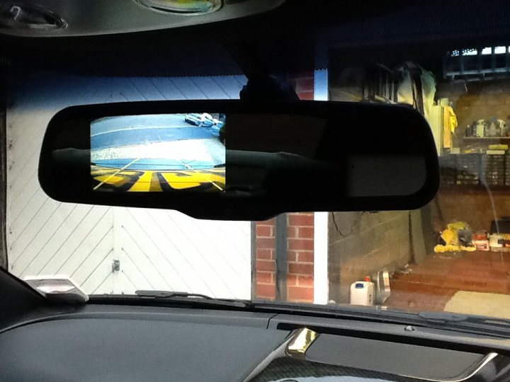 A person taking a picture of a car in a rear view mirror - Pistonheads