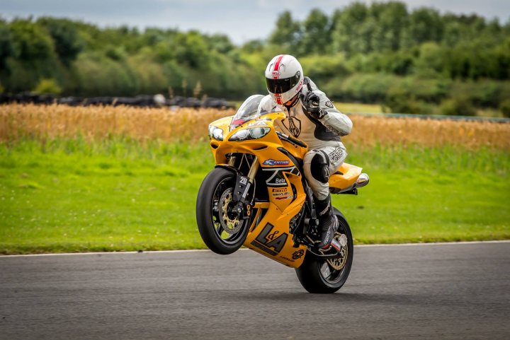 A man riding a motorcycle down a curvy road - Pistonheads