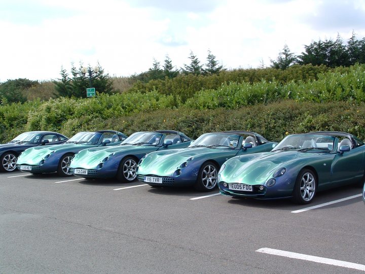 A row of parked cars sitting next to each other - Pistonheads