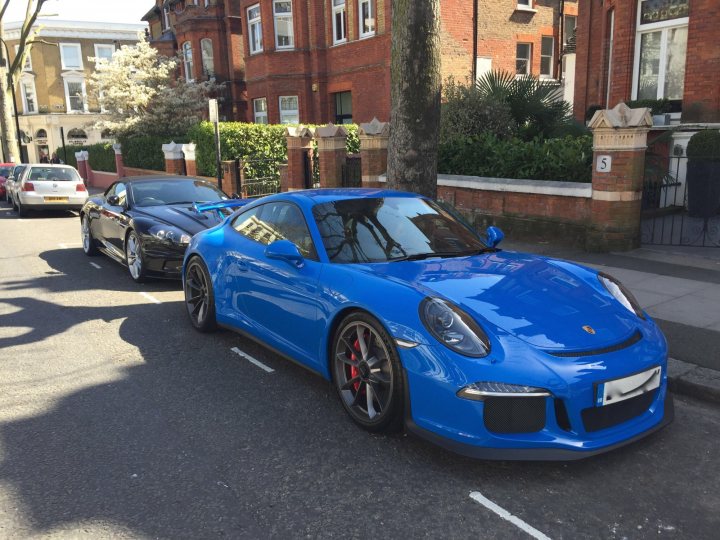 A blue car parked next to a red car - Pistonheads