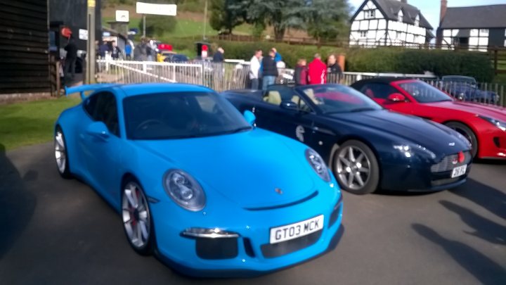 A blue car parked next to a red and white fire hydrant - Pistonheads