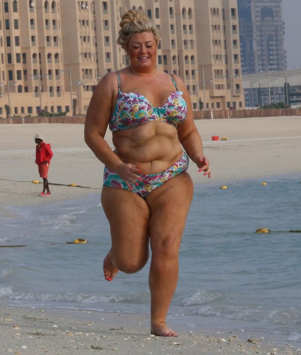 A woman in a bikini standing on a beach - Pistonheads