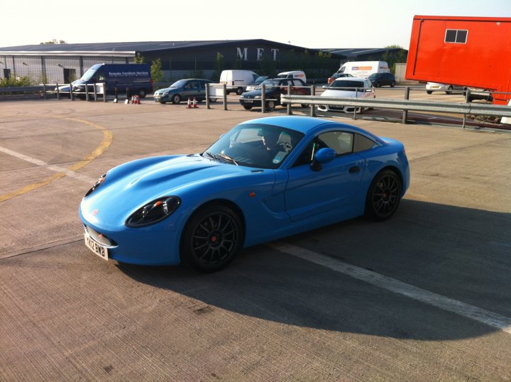 A blue car parked in a parking lot - Pistonheads