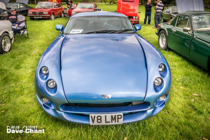 A blue car is parked in a field - Pistonheads