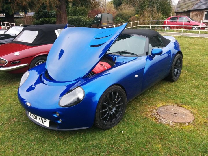 A blue and red car parked in a field - Pistonheads
