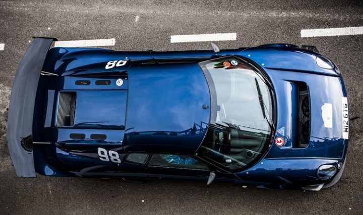 A blue car with a surfboard on top of it - Pistonheads