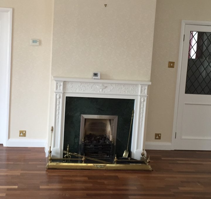 A fireplace in a living room with a fireplace