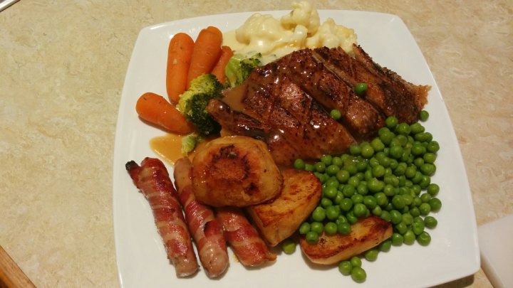 A white plate topped with meat and vegetables - Pistonheads