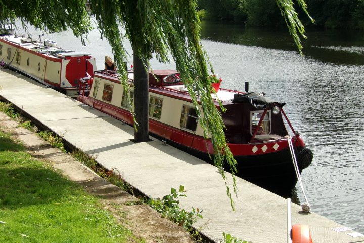 A red and white boat is docked at a dock - Pistonheads