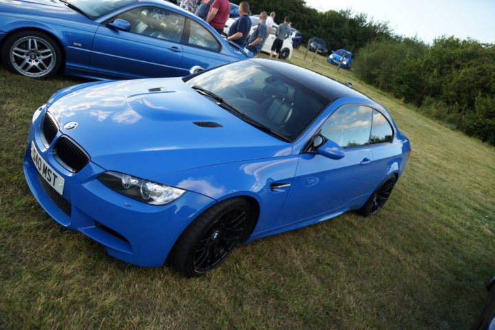 A blue car is parked on the grass - Pistonheads