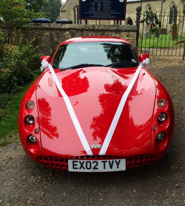 A red and white car with a red bow on top - Pistonheads