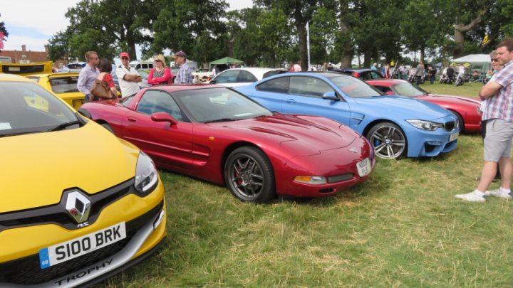 A red and blue car is parked in a field - Pistonheads