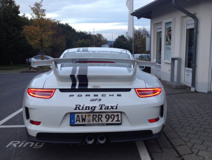 A white car parked in front of a building - Pistonheads