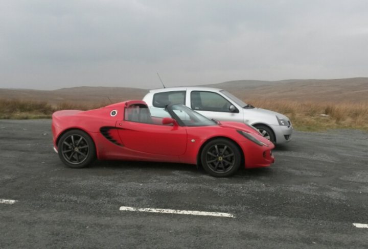 A red car is parked on the grass - Pistonheads