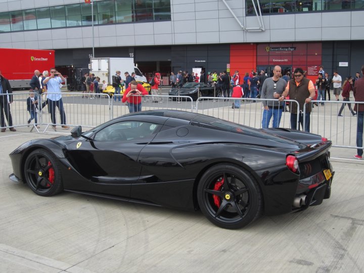 A black car parked in front of a building - Pistonheads
