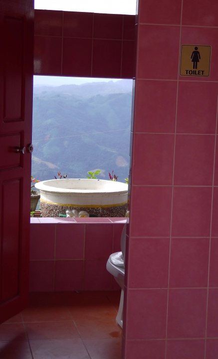 A bath room with a toilet a sink and a bath tub - Pistonheads