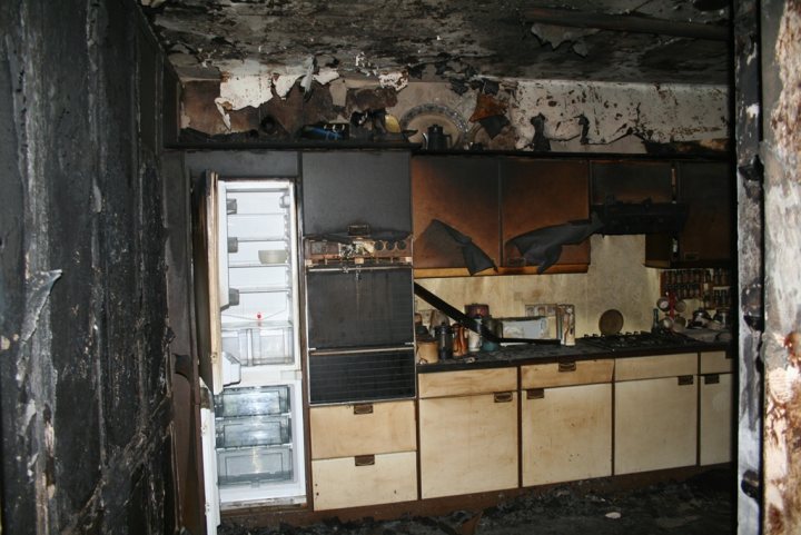 A kitchen with a stove top oven next to a window - Pistonheads