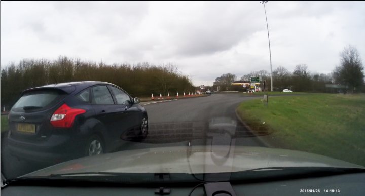 A car driving down a road next to a traffic light - Pistonheads