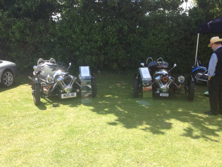 A row of parked motorcycles sitting next to each other - Pistonheads