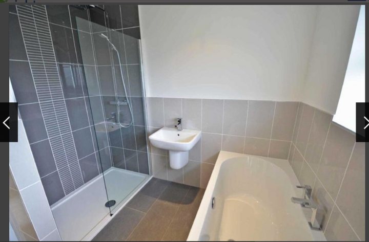 A bath room with a toilet a bath tub and a sink - Pistonheads