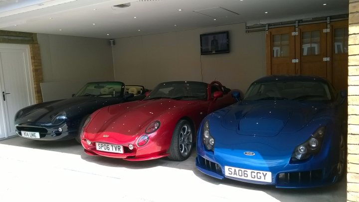A red car is parked in a parking lot - Pistonheads