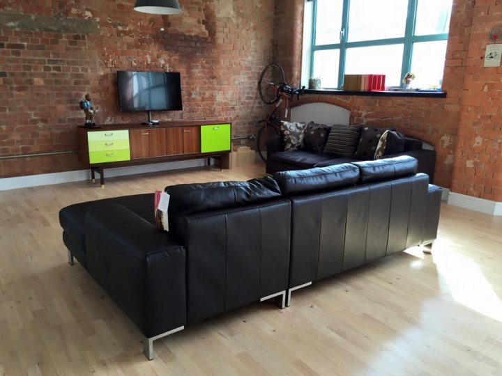 A living room filled with furniture and a flat screen tv - Pistonheads