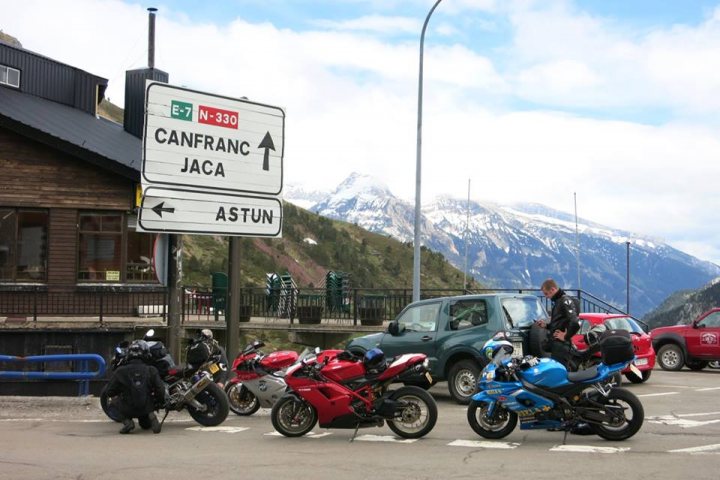 A group of motorcycles parked in a parking lot - Pistonheads